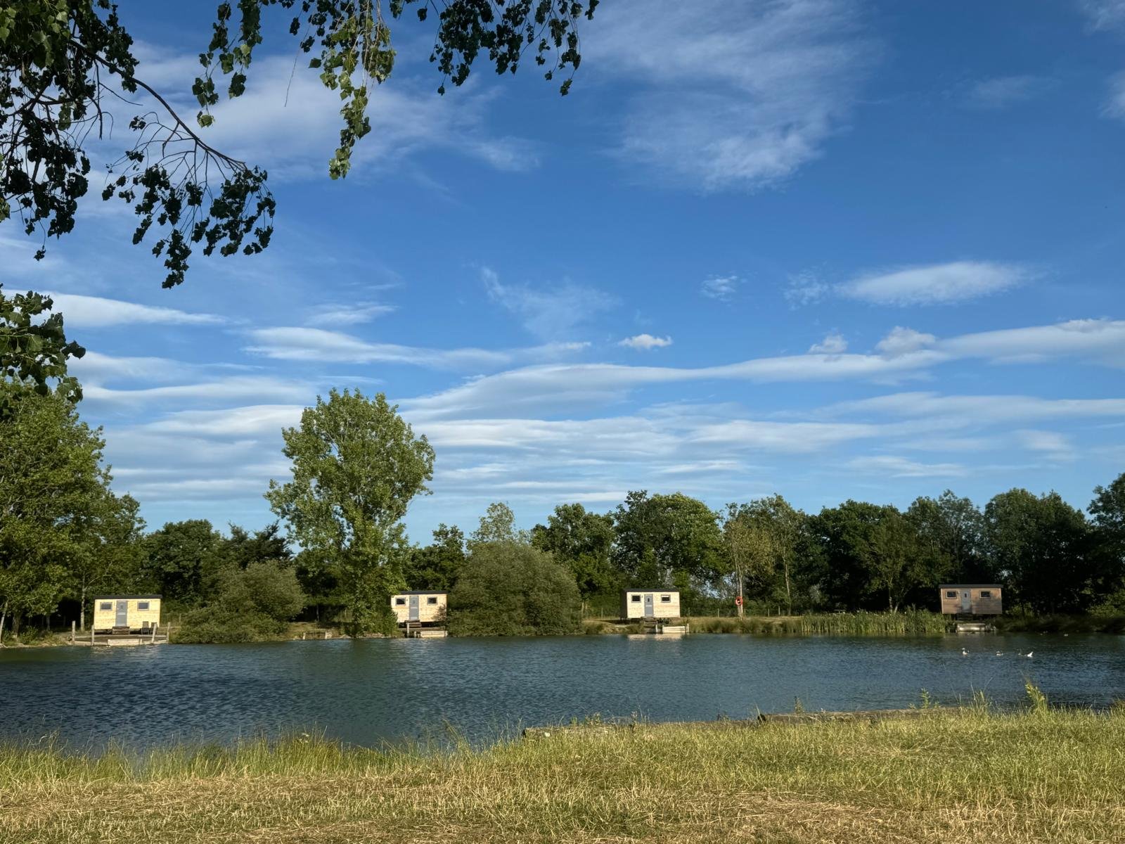 Shepherd hut locations seen from across the lake